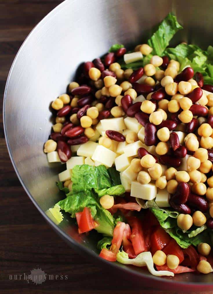 This southwestern chopped salad, with two kinds of beans, cubes of cheese, crunchy greens, and a tangy balsamic vinaigrette makes an easy weeknight meal.