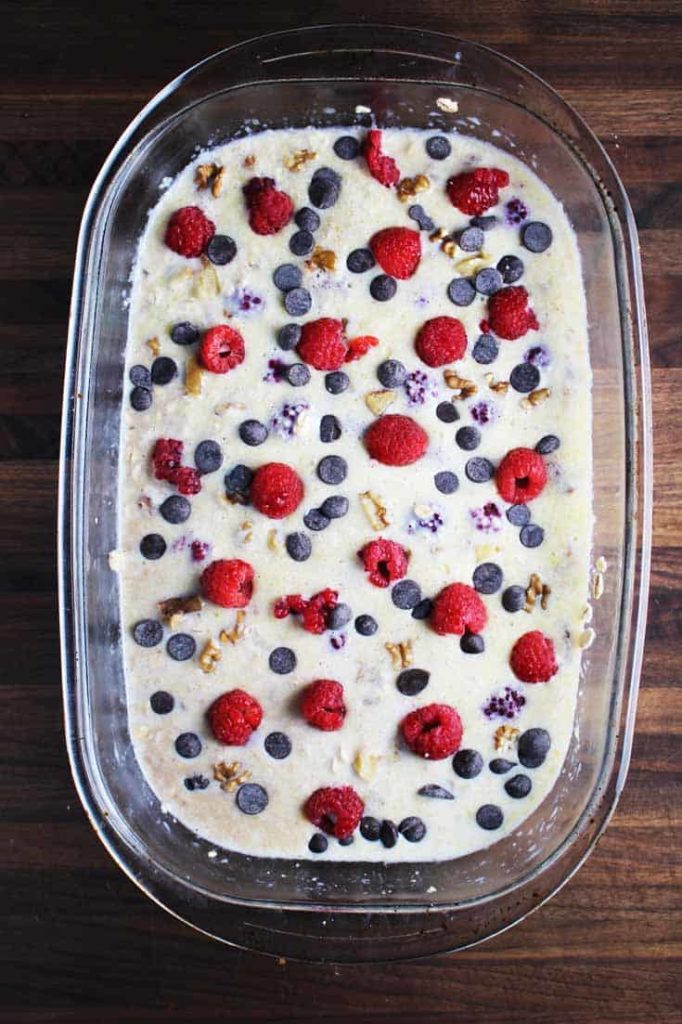 Unbaked raspberry dark chocolate baked oatmeal in a baking dish