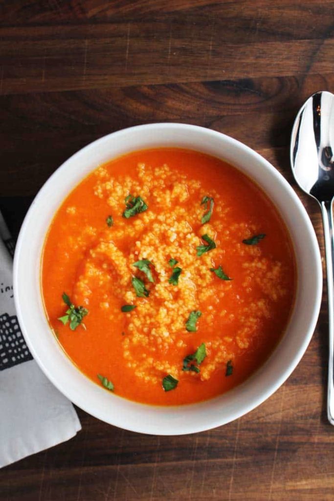 This red pepper carrot soup gets a ton of flavor from harissa, and is extra satisfying on a chilly fall evening with the amazing addition of a couscous swirl.