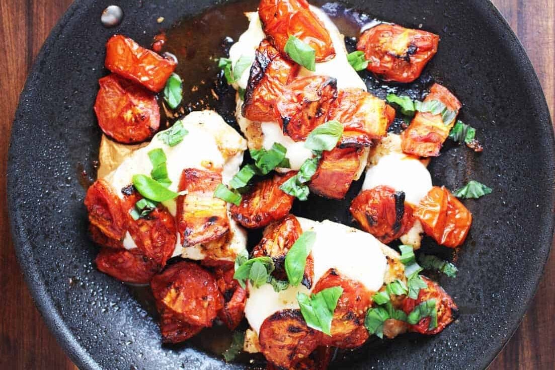 This caprese chicken with roasted tomatoes is easy and quick to make. Serve it with buttered noodles or a green salad for a simple, flavorful weeknight meal. #chickendinner #capresechicken #weeknightmeal