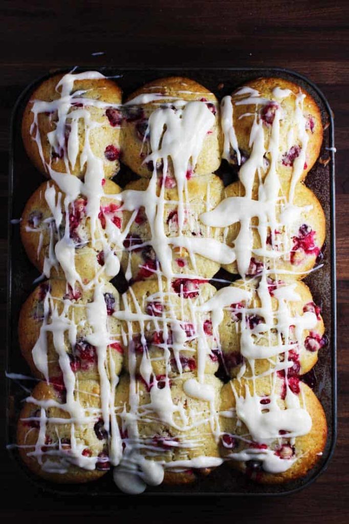 Overhead view of fresh cranberry orange muffins, drizzled with cream cheese glaze