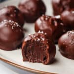 Closeup of the inside of a chocolate truffle on a plate.
