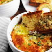 Baked eggs in purgatory in a bowl with a piece of garlic bread