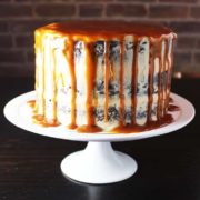 Caramel chocolate cake on a plate with coconut caramel frosting and caramel drizzle