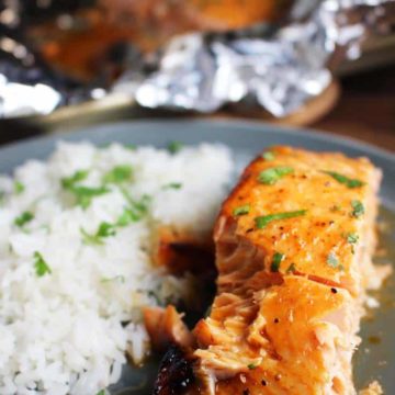 Closeup of sriracha salmon with baked cocount rice on a plate