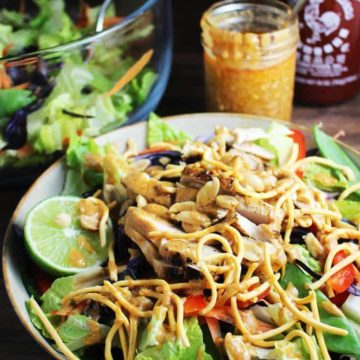 Asian chicken salad with sriracha peanut dressing in a bowl