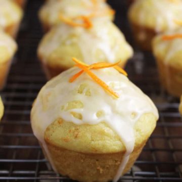 glazed mandarin orange muffins on a cooling rack