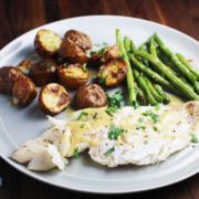fish, green beans and potatoes on a plate for a sheet pan dinner