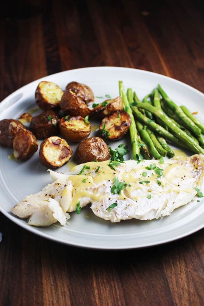 fish, green beans and potatoes on a plate for a sheet pan dinner