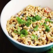 Large bowl of creamy taco macaroni salad sprinkled with cilantro