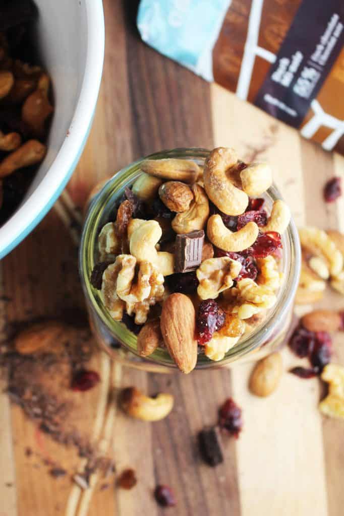 Healthy trail mix in a jar on a wooden board