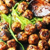 Asian meatballs with snow peas in a pan