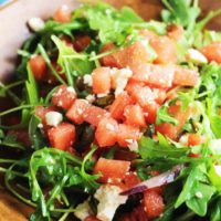 Watermelon arugula salad in a wooden bowl