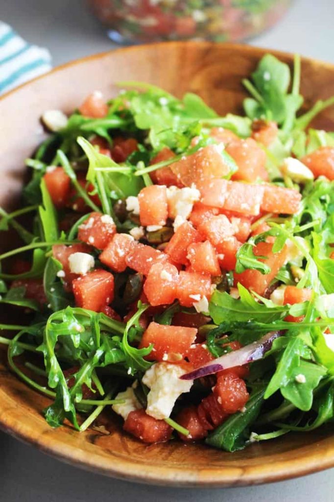 Watermelon arugula salad in a wooden bowl