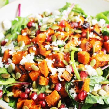 A bowl of roasted sweet potato salad with kale