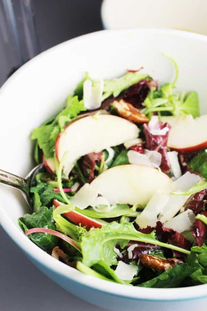 Fall salad with apples and maple dressing in a large salad bowl