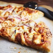 Slice of Buffalo chicken pizza on parchment paper