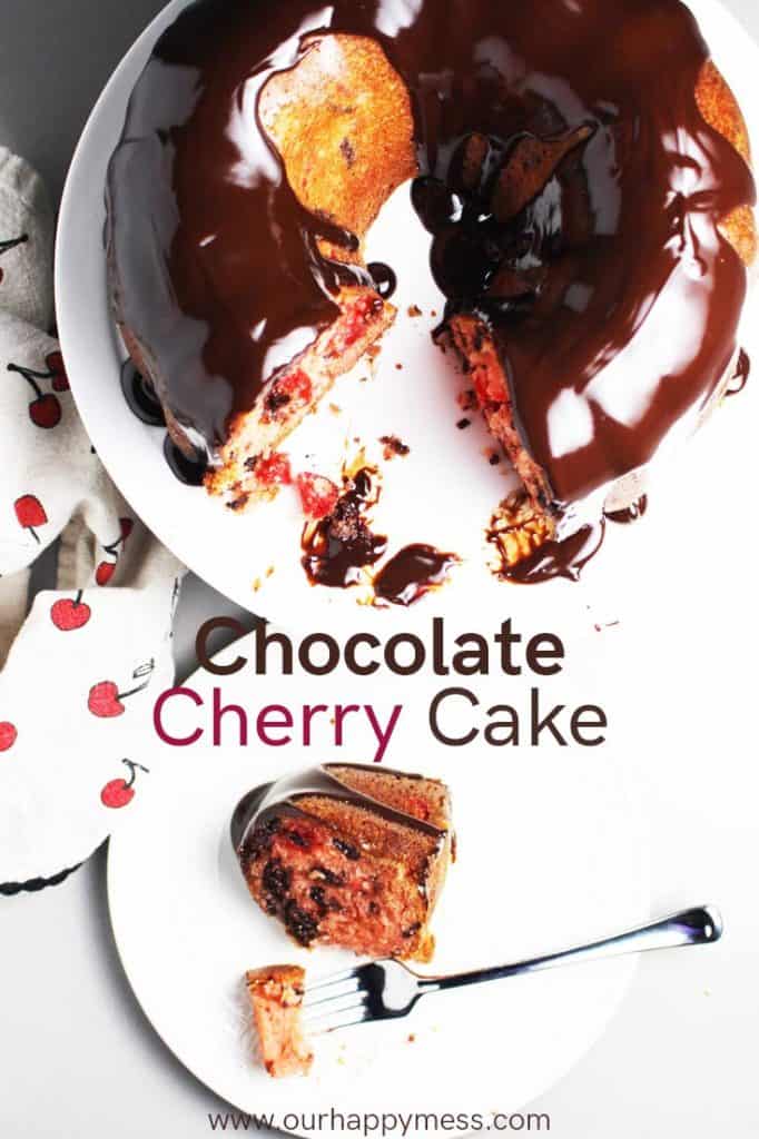 chocolate cherry cake on a cake stand with a piece of cake on a plate