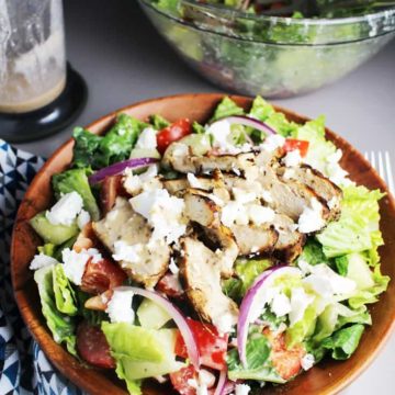Greek chicken salad in a wooden bowl