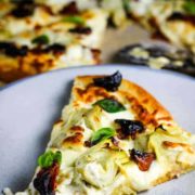 Slice of artichoke pizza on a plate
