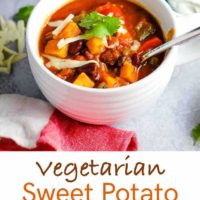 A bowl of vegetarian sweet potato chili topped with cheddar and cilantro