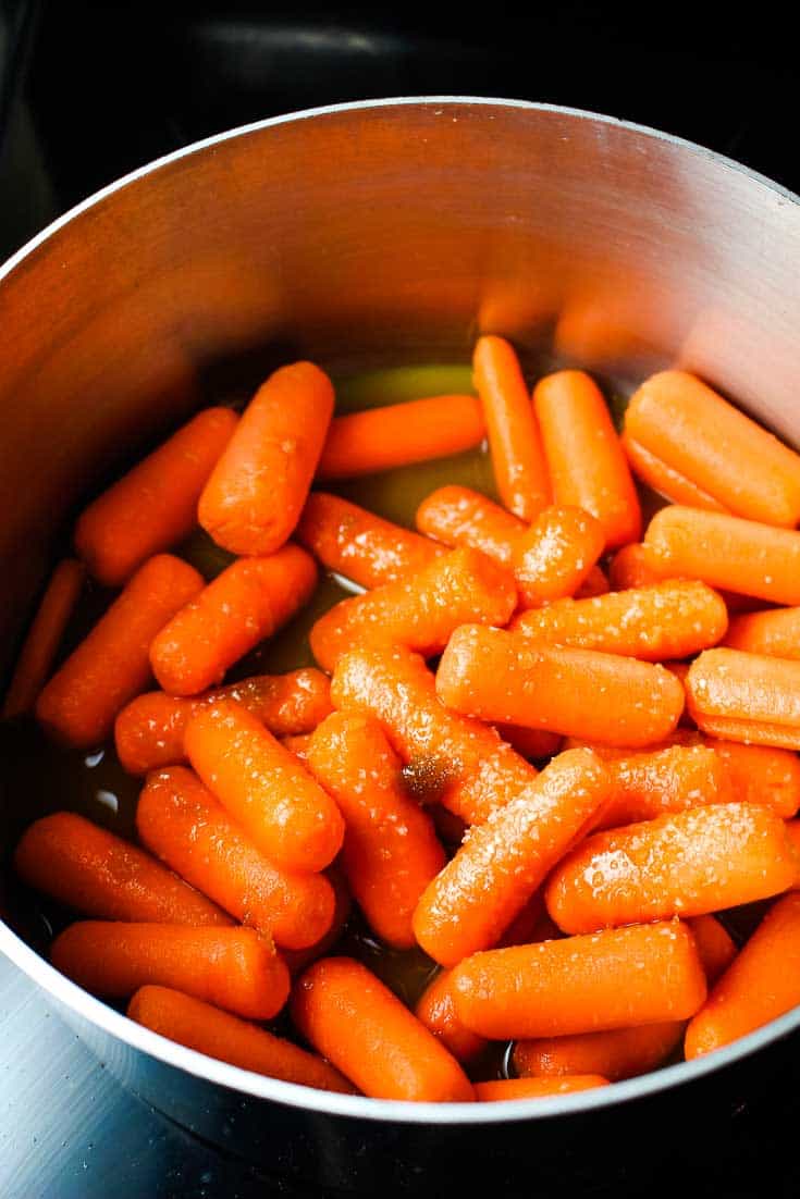 Baby carrots in a saucepan.