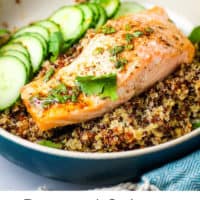 A roasted salmon filet on a bed of quinoa with cucumber slices