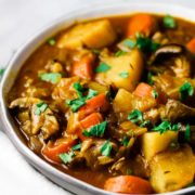 A bowl of vegetable stew sprinkled with parsley