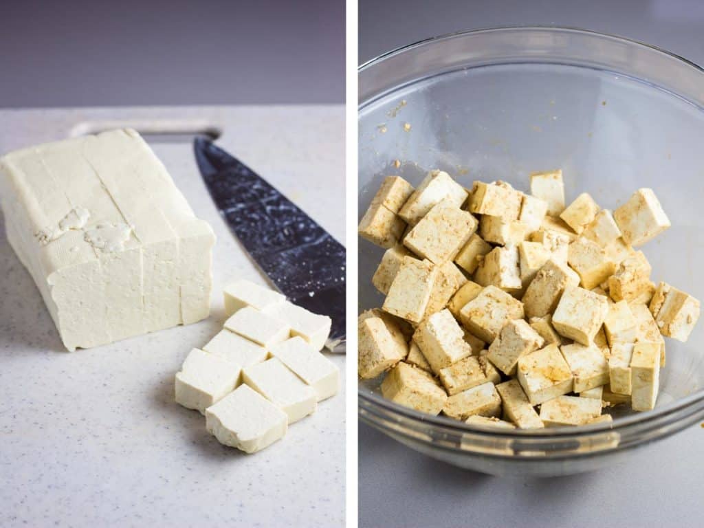 A block of tofu being cubed on a cutting board and marinating in soy sauce