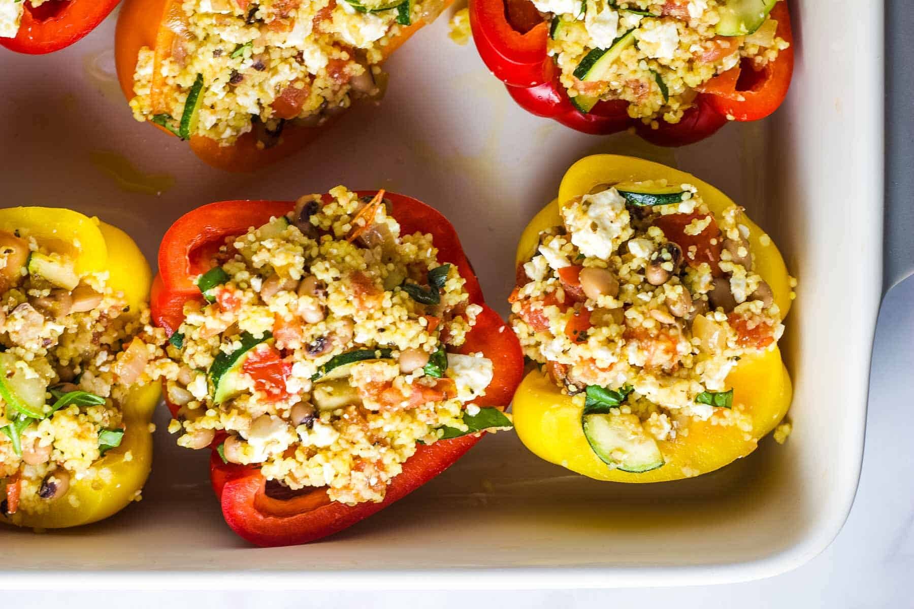 Uncooked stuffed peppers in a baking dish