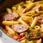 Closeup of Cajun sausage pasta with penne in a pan.