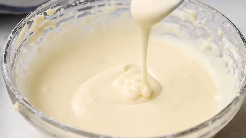 Cream cheese glaze for muffins in a bowl.