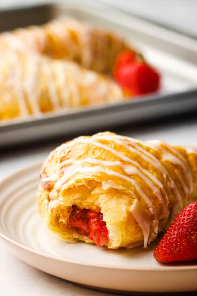 A sliced strawberry turnover on a plate.