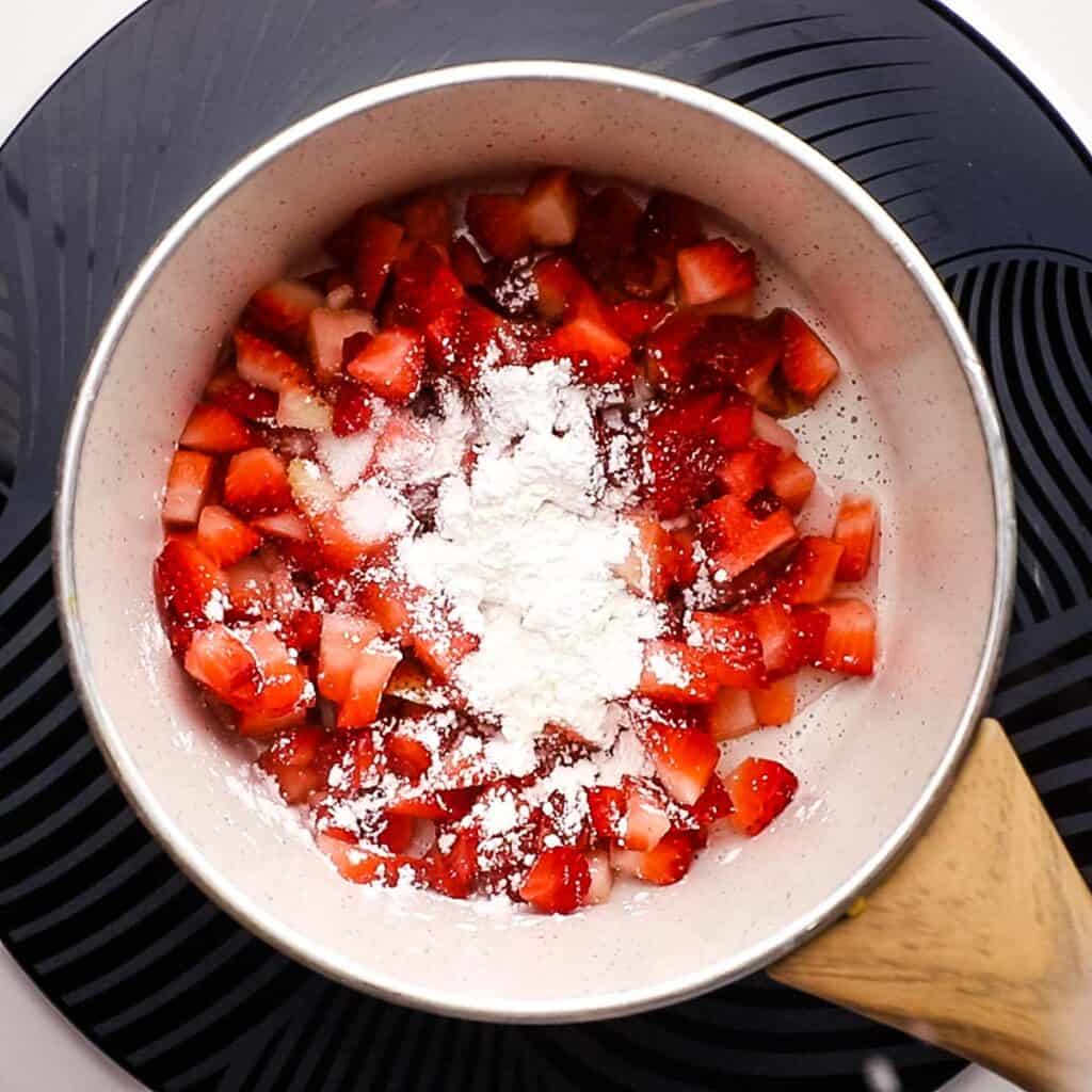 Strawberry sauce ingredients in a saucepan.