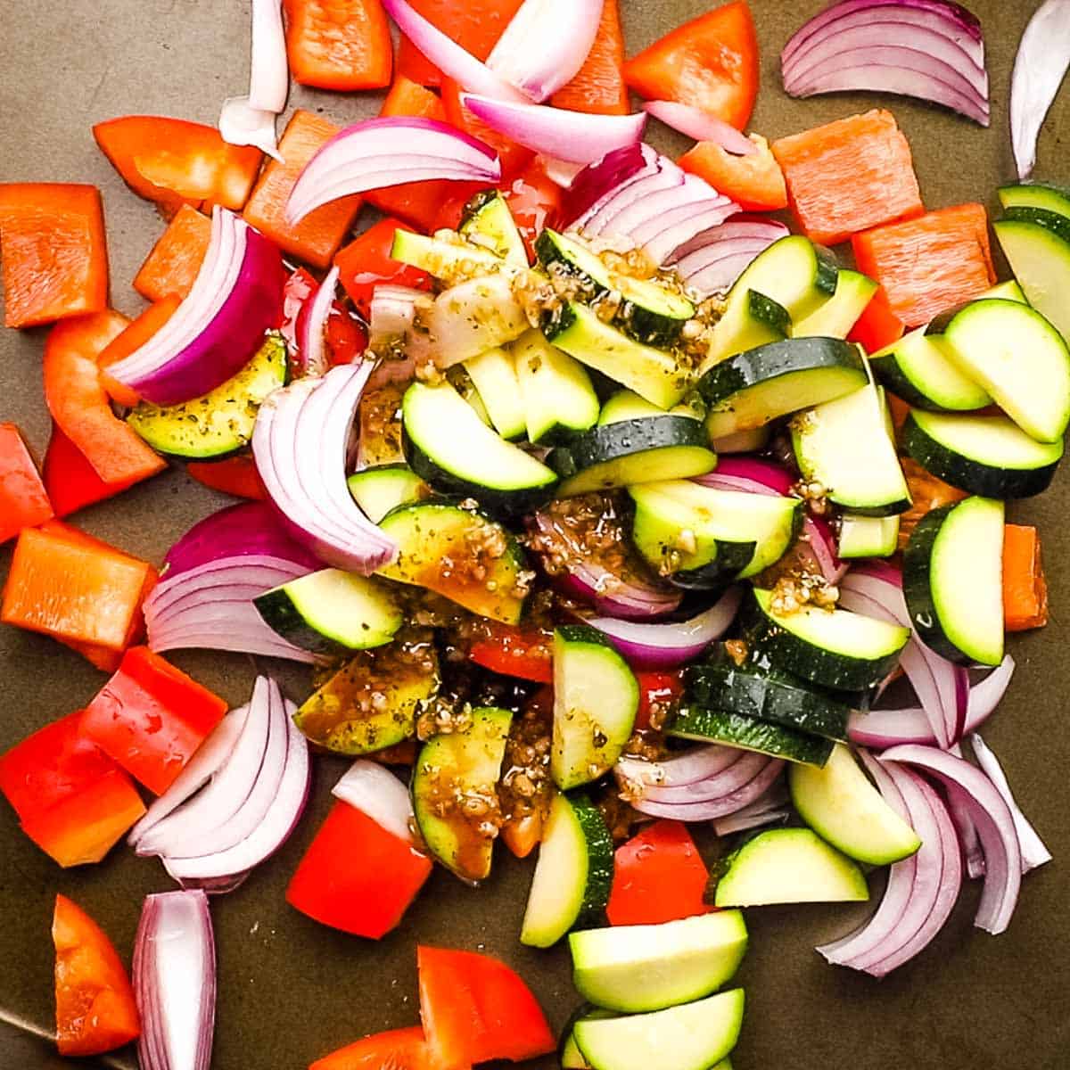 vegetables and oil mixture on a baking sheet.