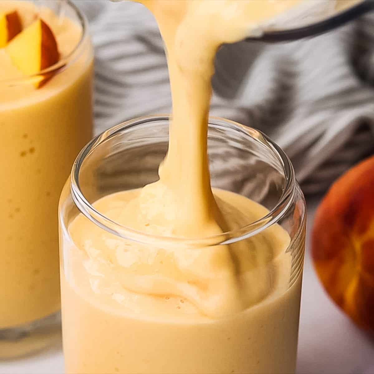 Pouring smoothie in a glass.