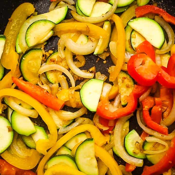 adding all the vegetables to the skillet