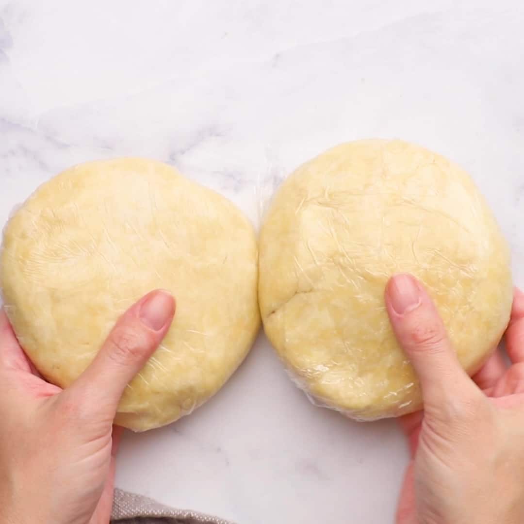 two equal sized balls of pie crust dough 