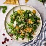Overhead view of a plate of ancient grains salad garnished with Parmesan cheese.