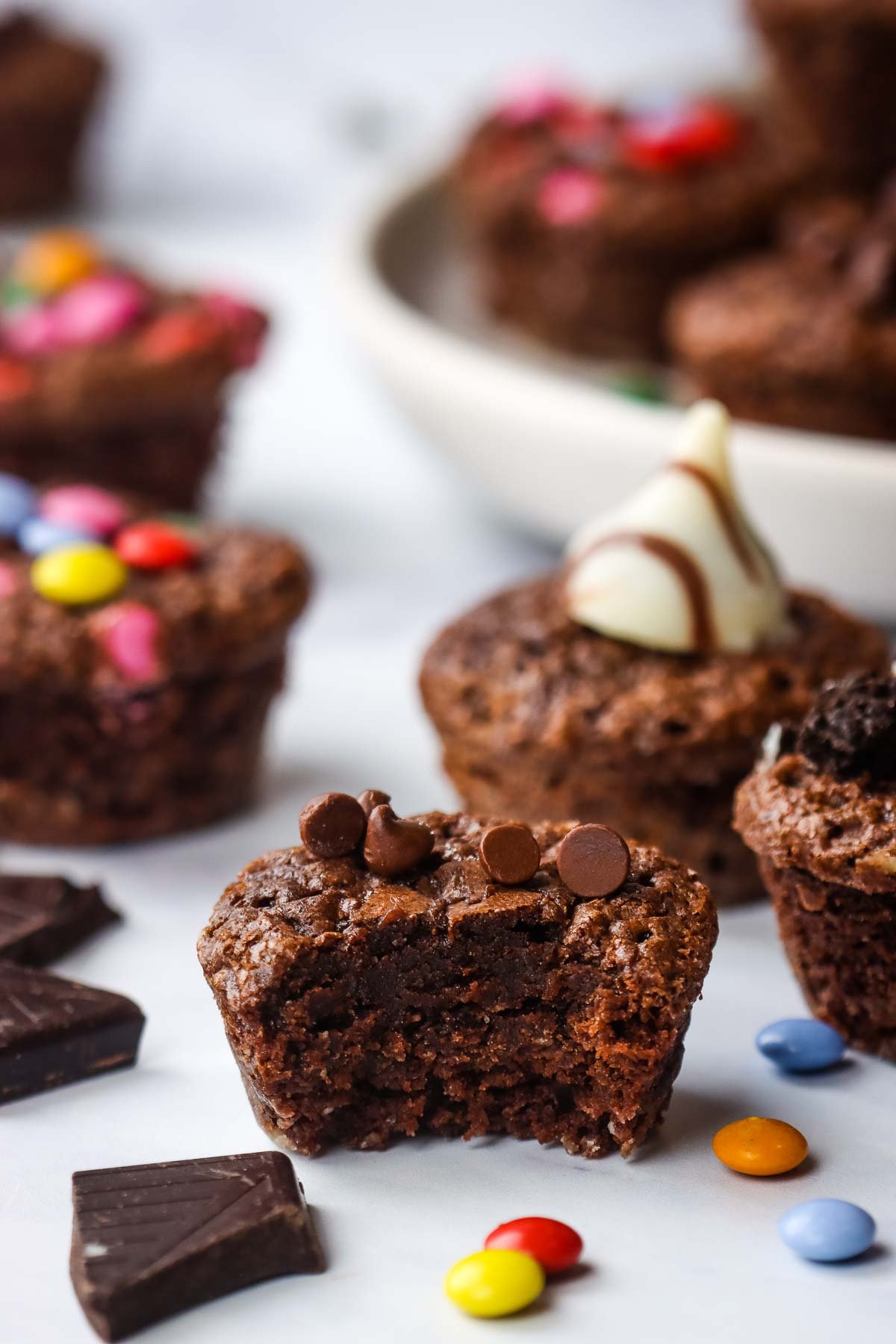 A close up of a mini brownie with a bite taken out to show the texture.