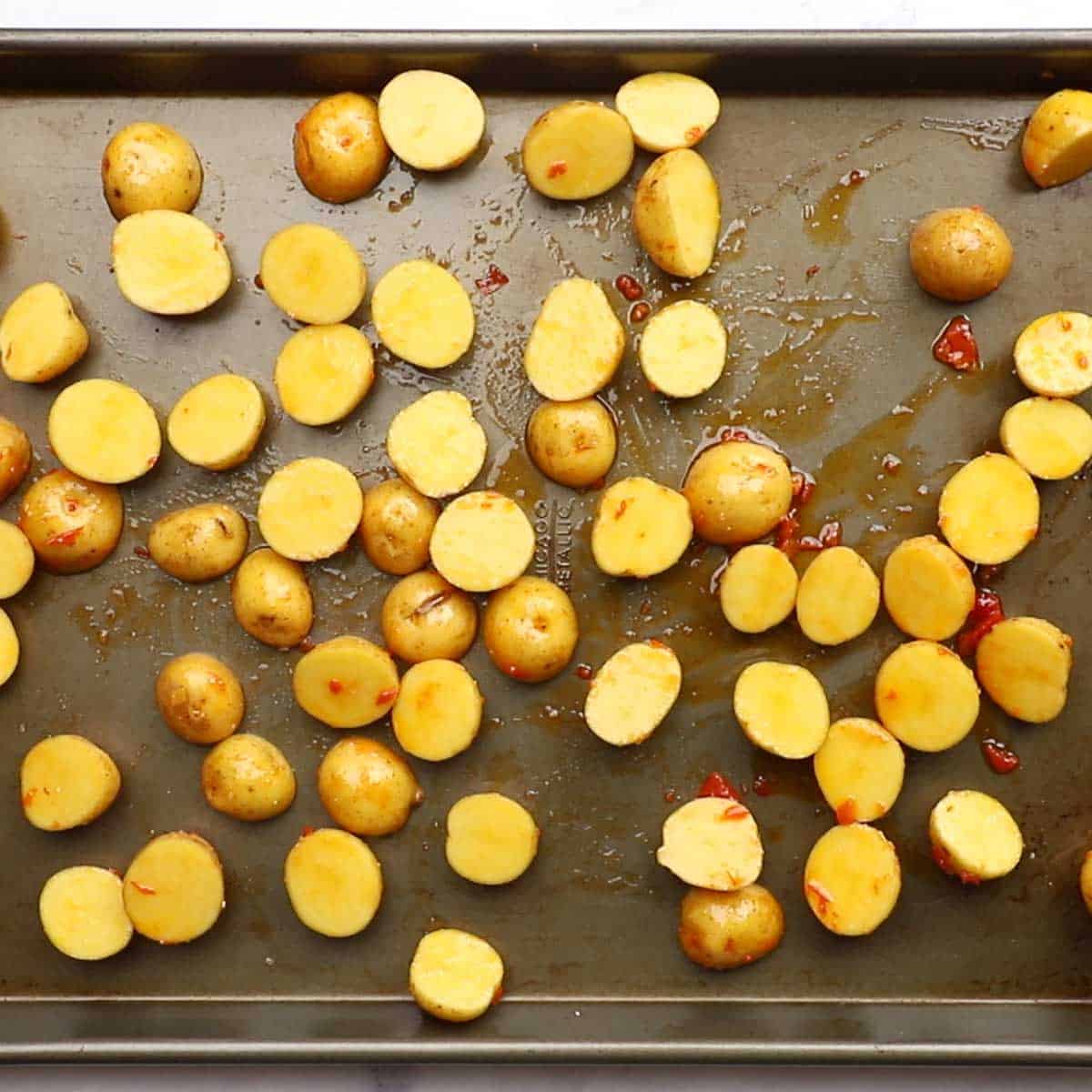 potatoes spread on a baking sheet