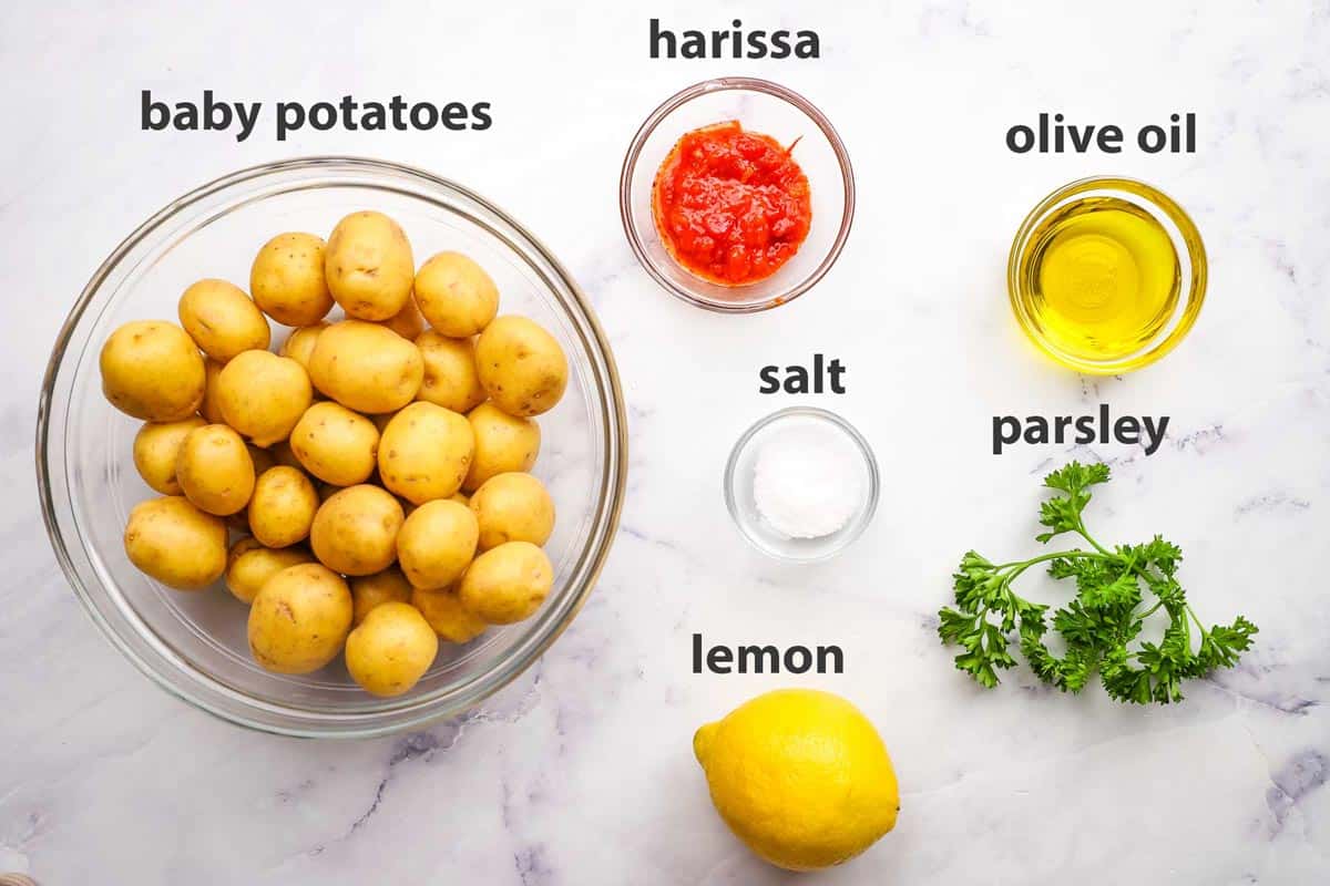 ingredients pictured and labelled for harissa potatoes