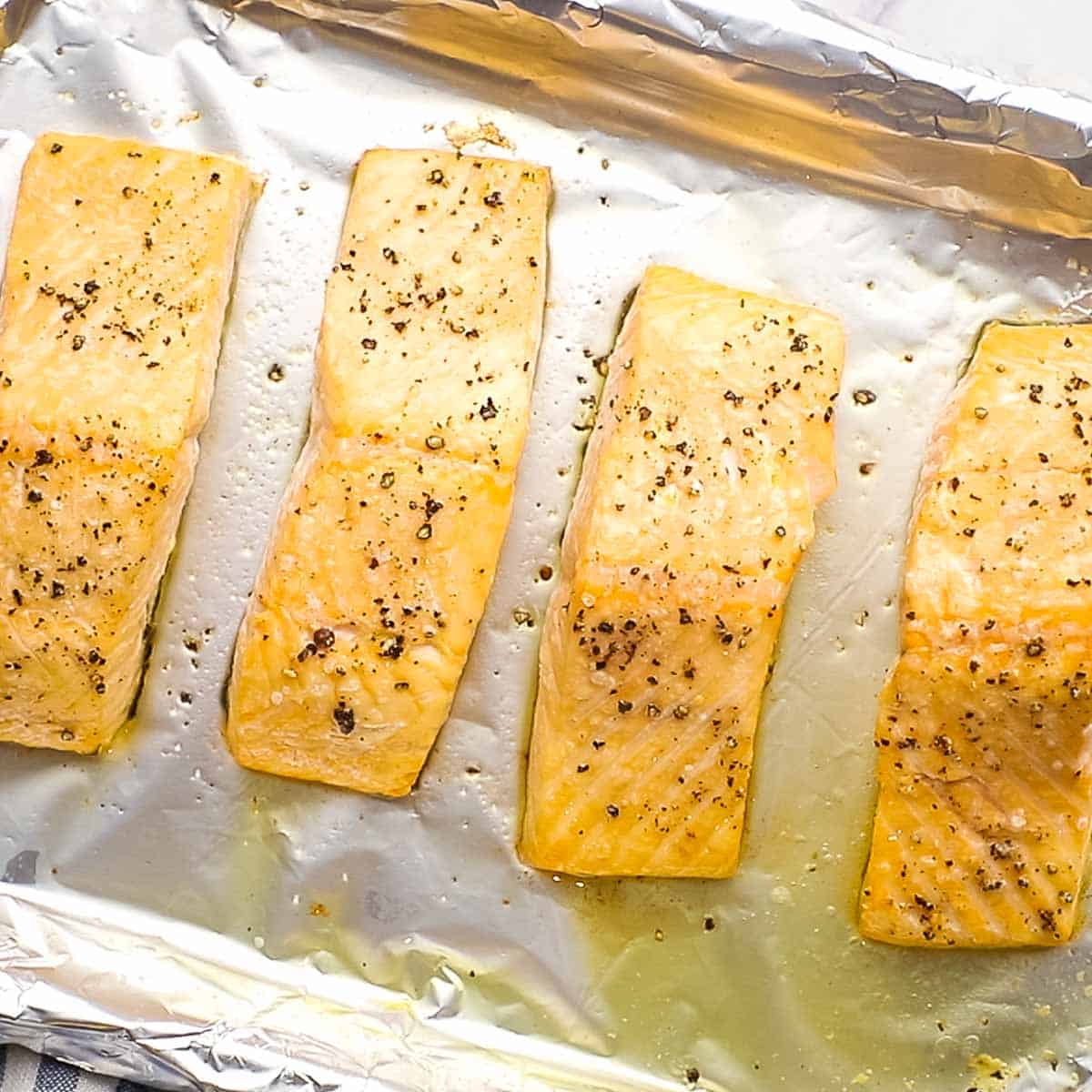 Roasted salmon filets on a baking sheet.