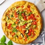 overhead view of a zucchini tomato tart served on a plater