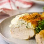 A close up of Boursin stuff chicken sliced in half to show the inside.