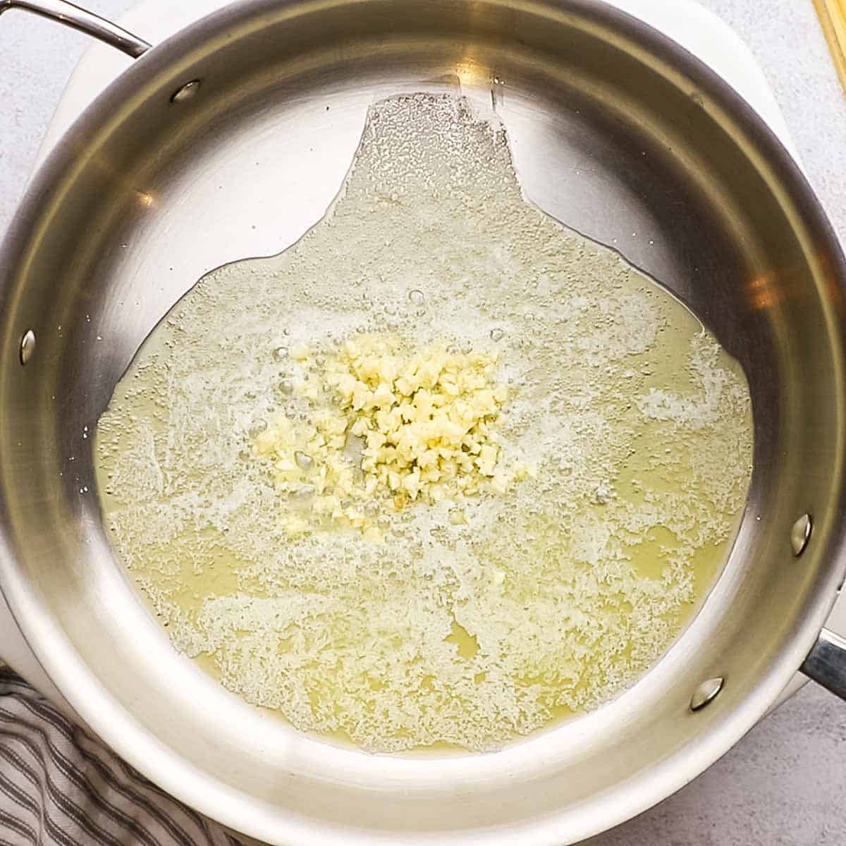 overhead view of a pot with butter and garlic