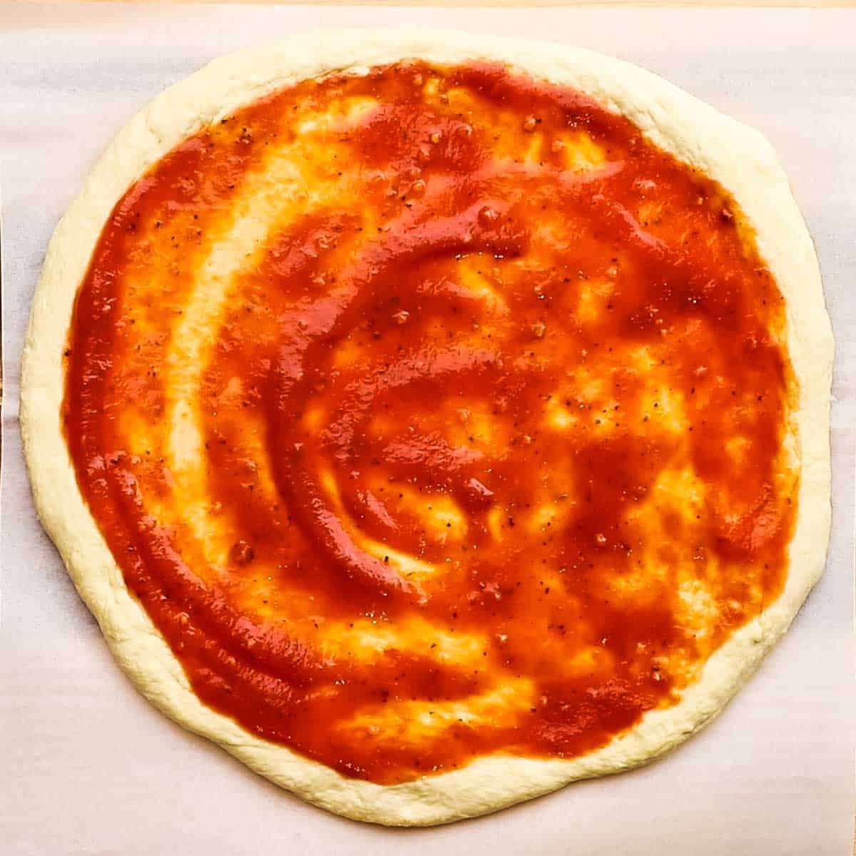 pizza sauce spread on the dough