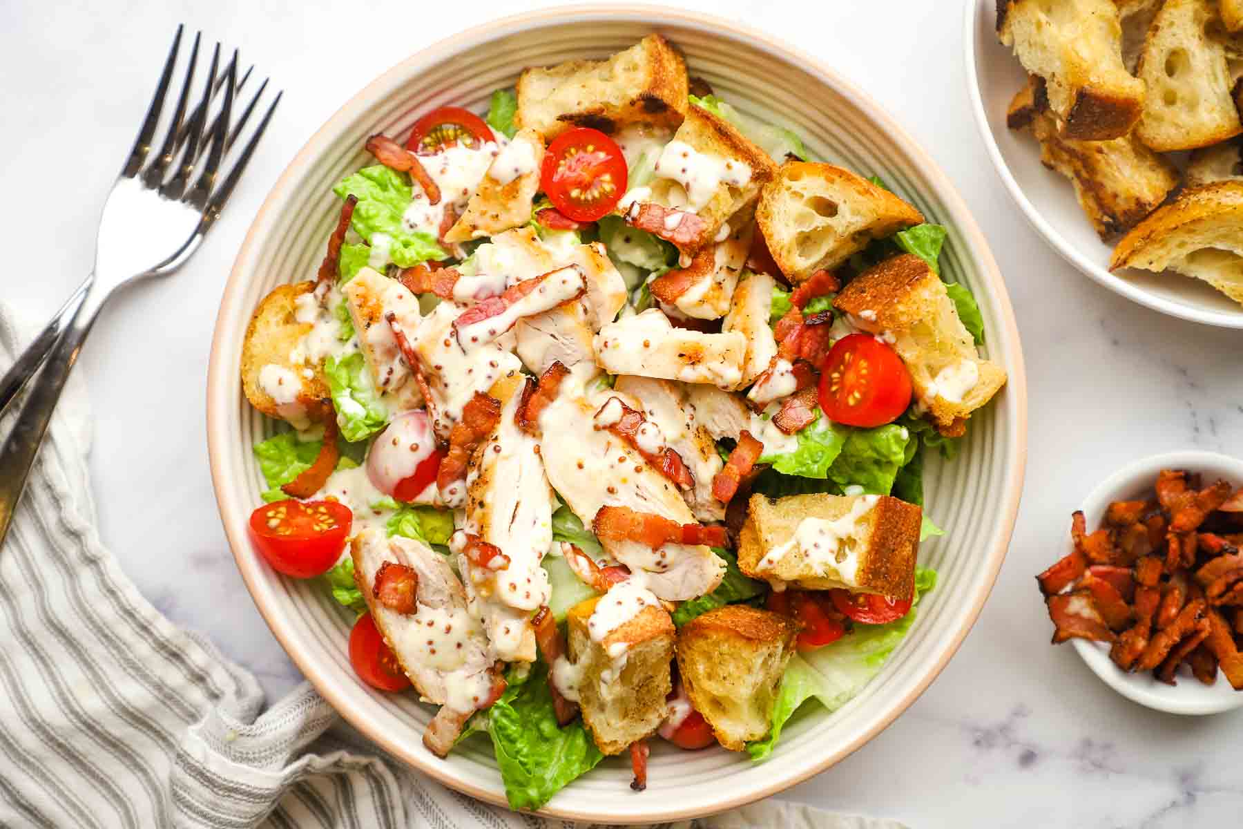 anoverhead view of a blt  salad with chicken on a plate