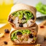 Closeup of two halves of a chicken sandwich wrap stacked on top of each other.
