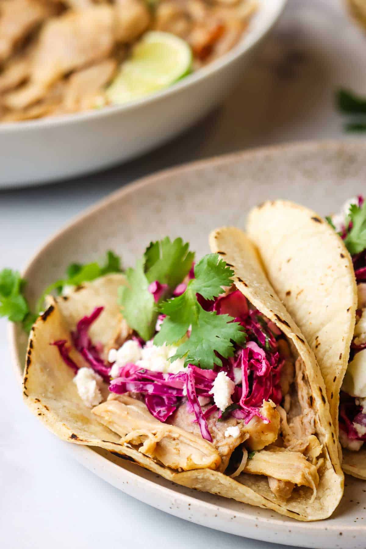 one chicken taco with cilantro lime slaw in a plate